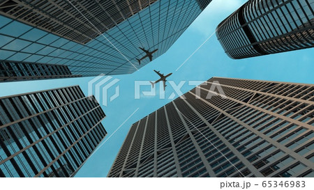 Airplane flies over skyscrapers in modern city 65346983