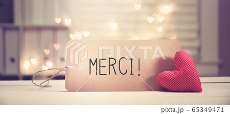 Merci - Thank you in French language with a red heart Merci - Thank you in French language with a red heart 65349471