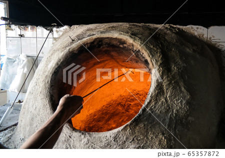 Baking the bread in tandoor, Manama, Bahrain Baking the bread in tandoor, Manama, Bahrain 65357872