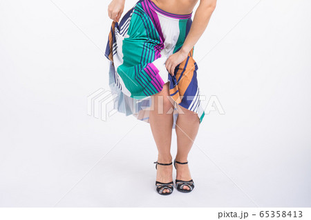 Latina dance, salsa, contemporary and bachata lady concept - Woman dancing improvisation on a white background close-up. 65358413