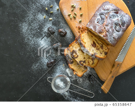 Homemade dates bread with walnuts on a black table 65358647