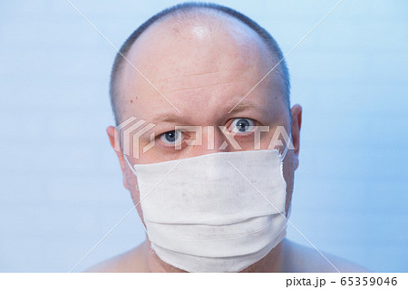 Portrait of a bald man who is in a medical mask. 65359046