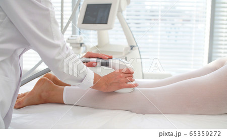 woman uses a professional device during a vacuum massage procedure woman uses a professional device during a vacuum massage procedure 65359272