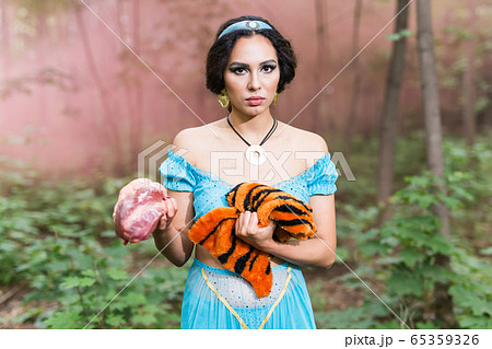Stop animal killing concept - Pretty girl show animal skin that she wants to tell someone don't kill animals or stopped violence against animal. Stop animal killing concept - Pretty girl show animal skin that she wants to tell someone don't kill animals or stopped violence against animal. 65359326
