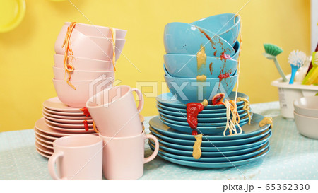 Pile of dirty dishes after the party on the table. The concept of laziness Pile of dirty dishes after the party on the table. The concept of laziness 65362330