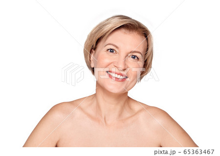 Beauty Conept. Mature woman standing isolated on white close-up posing to camera toothy 65363467