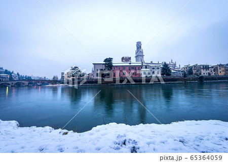 River Adige and Verona cityscape in winter with snow - Veneto Italy 65364059