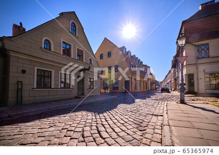 Cobbled pavements of old town streets in Klaipeda, Lithuania on sunny day. Old buildings, houses, galleries, shops, restaurants 65365974