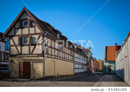 Typical fachwerk houses of old Klaipeda, Lithuania medieval town and cobbled pavement street. German style buildings of Middle Ages. 65366169