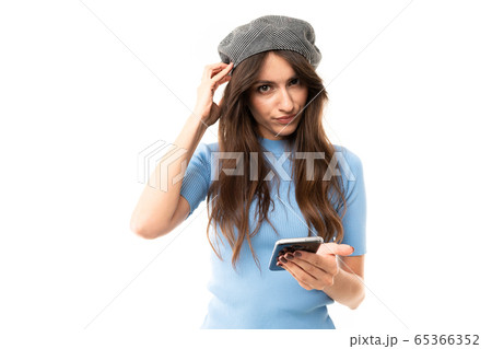 Cheerful woman with long hair serfing internet with her phone isolated on white background Cheerful woman with long hair serfing internet with her phone isolated on white background 65366352