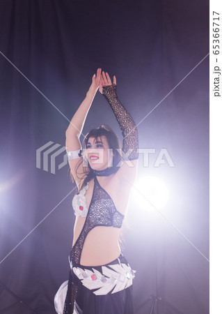 Spirituality dance. Beautiful sexy woman with luxury glossy eastern make-up dancing tribal fusion. Belly dance. 65366717