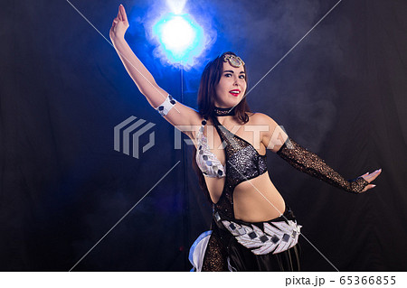 Spirituality dance. Beautiful sexy woman with luxury glossy eastern make-up dancing tribal fusion. Belly dance. 65366855