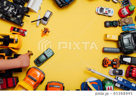 Children's cars toys for developing baby games on a yellow background Children's cars toys for developing baby games on a yellow background 65368945