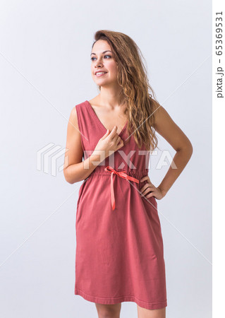 Fashion, summer and vacation concept - beautiful female model in brown dress on white background. 65369531