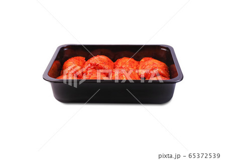 Chicken legs in red marinade in plastic packaging for supermarkets.Vacuum packaging.Fresh, raw chicken thigh in the package.Isolated Chicken legs in red marinade in plastic packaging for supermarkets.Vacuum packaging.Fresh, raw chicken thigh in the package.Isolated 65372539