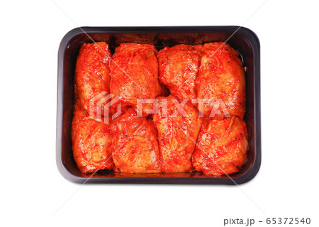 Chicken legs in red marinade in plastic packaging for supermarkets.Vacuum packaging.Fresh, raw chicken thigh in the package.Isolated Chicken legs in red marinade in plastic packaging for supermarkets.Vacuum packaging.Fresh, raw chicken thigh in the package.Isolated 65372540