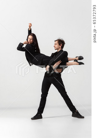 Young and graceful ballet dancers in minimal black style isolated on white studio background Young and graceful ballet dancers in minimal black style isolated on white studio background 65372793
