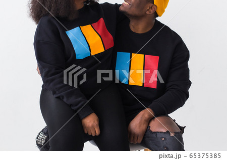 Close-up of happy African American woman and man have relationships, toothy smile, happy to meet with friends, dressed casually on white background. Emotions and friendship concept. 65375385