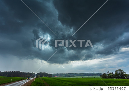 Storm clouds with shelf cloud base and intense rain Storm clouds with shelf cloud base and intense rain 65375497