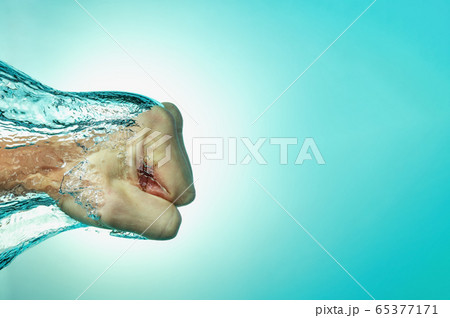 Man hit the water, the concept of strength and self-confidence, assertiveness and success. Close up on a blue background. Man hit the water, the concept of strength and self-confidence, assertiveness and success. Close up on a blue background. 65377171