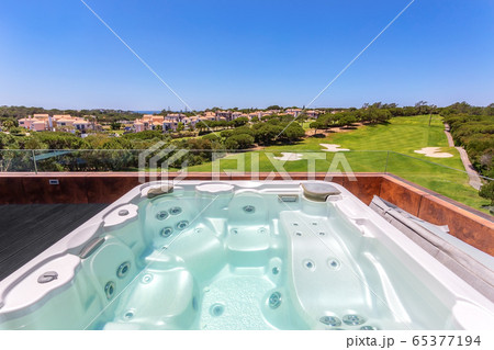 Modern luxurious pool, jacuzzi with hydromassage, with beautiful views and greenery, for tourists, in the hotel. Modern luxurious pool, jacuzzi with hydromassage, with beautiful views and greenery, for tourists, in the hotel. 65377194