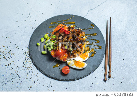 Poke bowl with raw salmon, rice, pineapple and vegetables 65378332