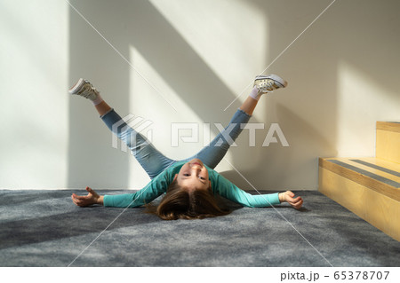 Cute kid lying on the floor and raising legs 65378707