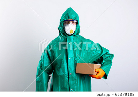 Disinfectant worker with cardboard box in his hand stock photo 65379188