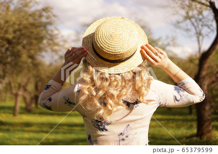 Girl in a straw hat. Back view. Trendy casual summer or spring outfit Girl in a straw hat. Back view. Trendy casual summer or spring outfit 65379599