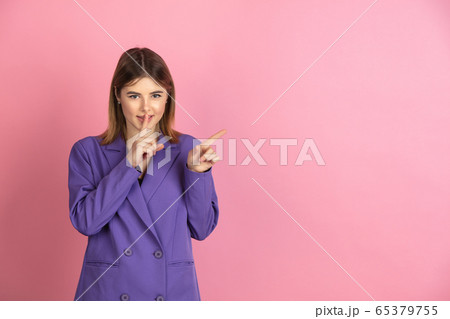 Caucasian young woman's portrait on pink studio background, emotional and expressive Caucasian young woman's portrait on pink studio background, emotional and expressive 65379755