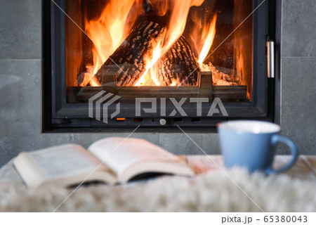 Hygge concept with book and tea 65380043
