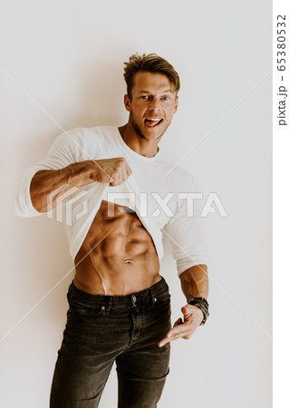 Muscular man on a diet showing abs muscles Muscular man on a diet showing abs muscles 65380532