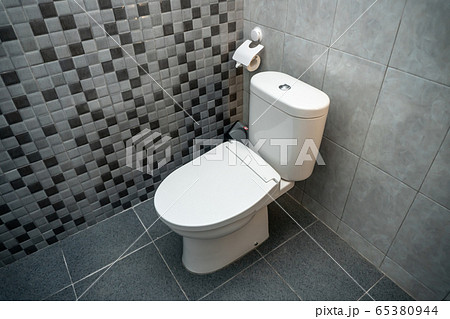 Photo of a white closed toilet in a toilet room Photo of a white closed toilet in a toilet room 65380944