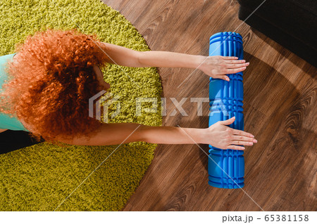Up view of woman with yoga roller Up view of woman with yoga roller 65381158