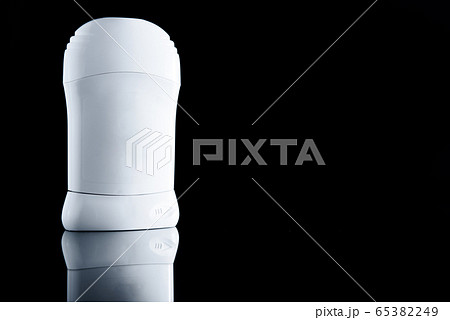 White antiperspirant deodorant standing on black background. Skin care concept. 65382249