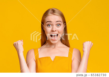 Big Win. Overjoyed Teen Girl Emotionally Rejoicing Success With Raised Fists Big Win. Overjoyed Teen Girl Emotionally Rejoicing Success With Raised Fists 65382730