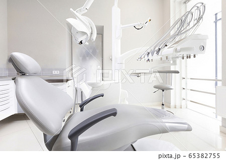 Dentist chair and other medical accessories in room 65382755