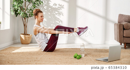 Happy woman doing sports exercise at home. 65384310