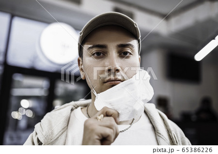 A man puts on a mask from a virus. Flu epidemic. 65386226