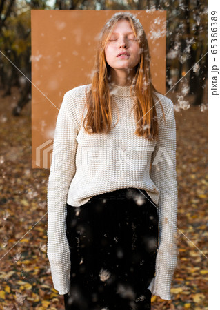 Female model in white jumper with flying fuzz Female model in white jumper with flying fuzz 65386389