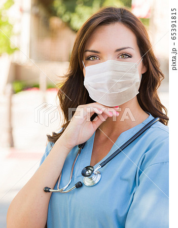 Female Doctor or Nurse Wearing Protective Face Mask 65391815
