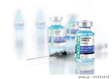 Coronavirus COVID-19 Vaccine Vials and Syringe On Reflective Surface. Coronavirus COVID-19 Vaccine Vials and Syringe On Reflective Surface. 65391819