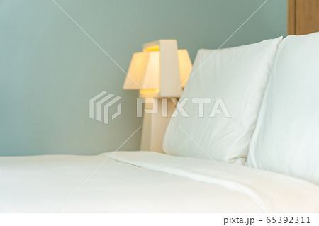 Pillow and blanket on bed with light lamp decoration interior 65392311