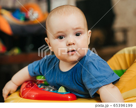 portrait of a cute Caucasian baby boy in a Walker portrait of a cute Caucasian baby boy in a Walker 65396199