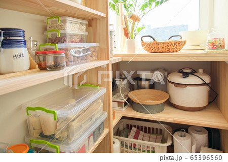Wooden shelves with food and utensils, kitchen appliances in the pantry 65396560