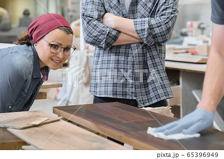 Woodworking workshop, worker varnishing wooden shelf closeup 65396949