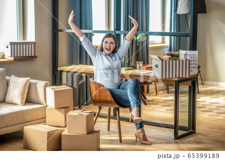 Young woman in casual clothes feeling excited and raising her hands 65399189