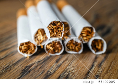 Close up of a hndmade smoking cigarettes on wooden 65402005