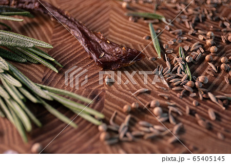 Close-up of a piece of meat on a wooden Board with spices. Restaurant menu, a series of photos of different dishes 65405145