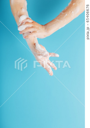 Hands of a child in soapy antibacterial foam, on a 65406676